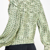 Woman wearing a green textured sweater on a white background