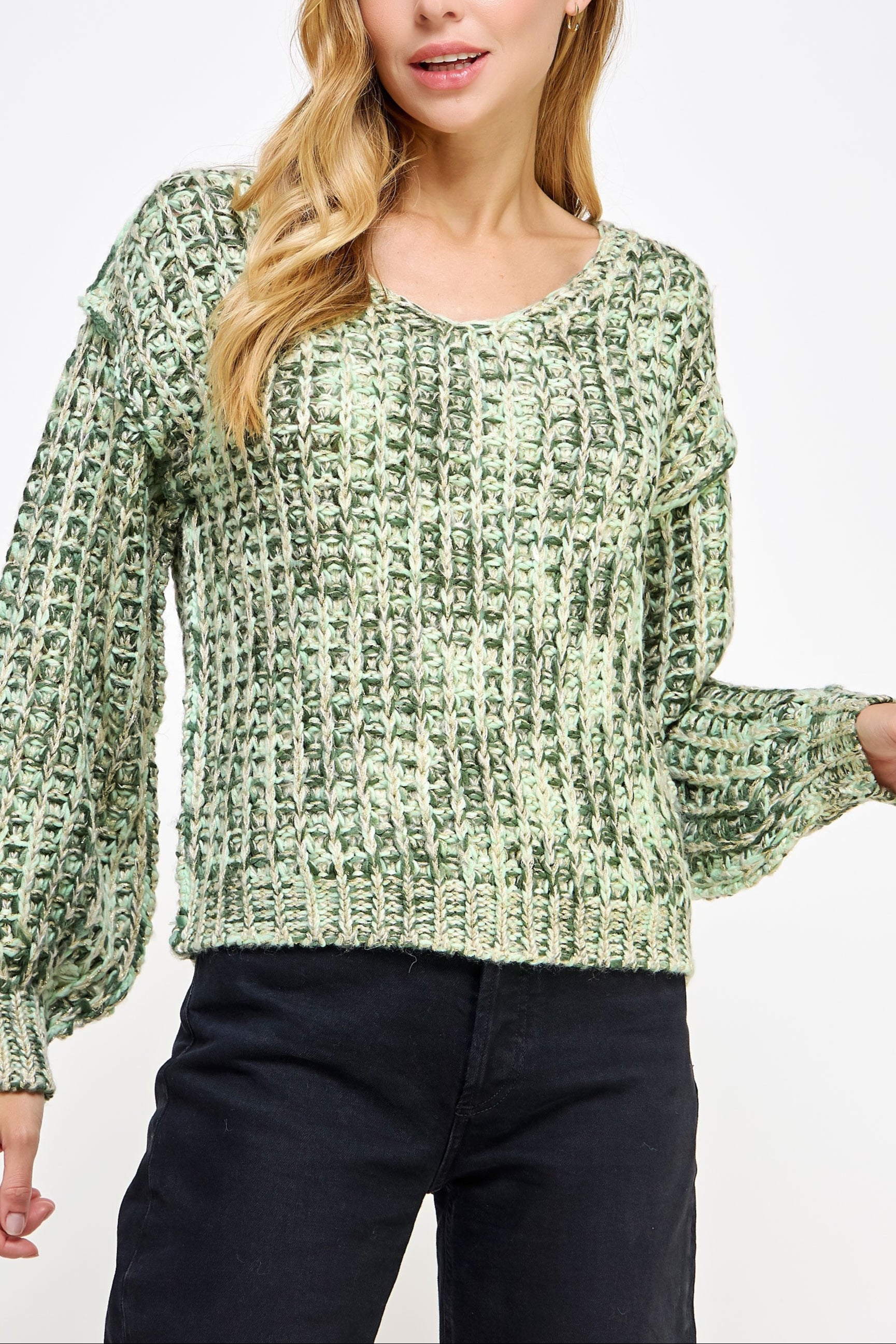 Woman wearing a green patterned sweater against a white background