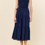 Woman wearing a navy blue dress on a beige background