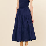 Woman wearing a navy blue dress on a beige background