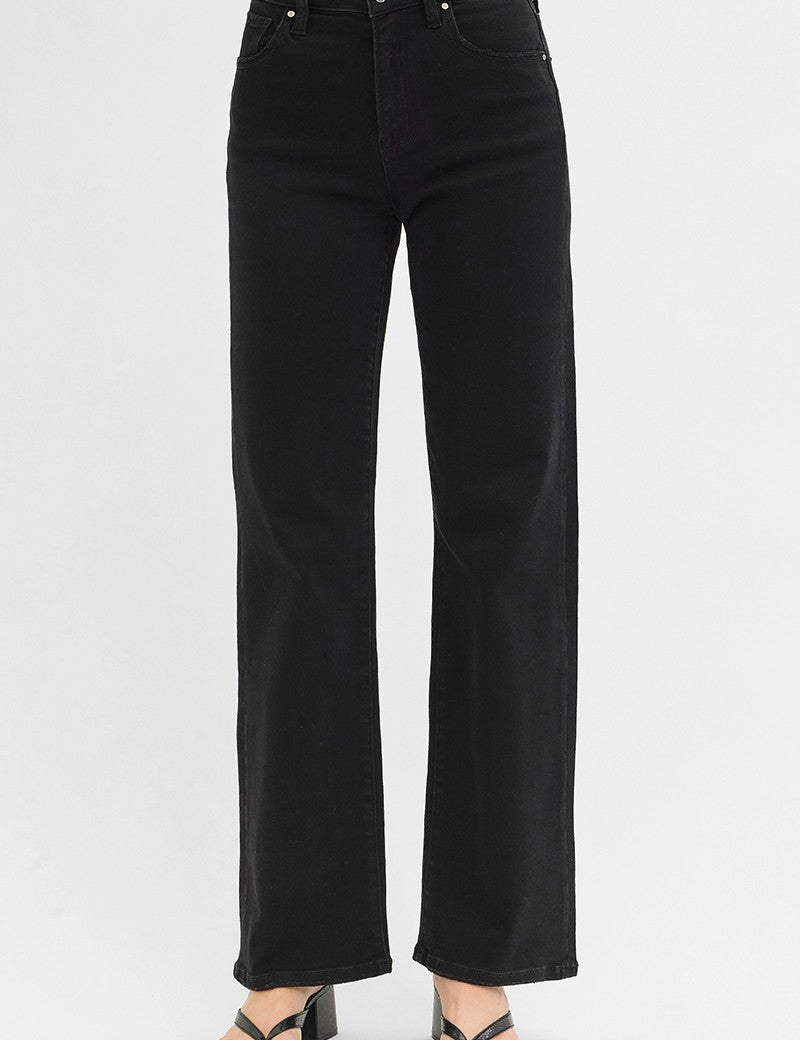 Black jeans worn by a person on a white background