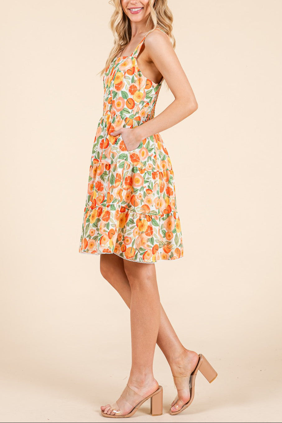 Woman wearing a floral dress on a beige background