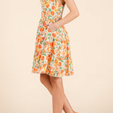 Woman wearing a floral dress on a beige background