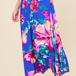 Woman wearing a colorful floral outfit on a beige background
