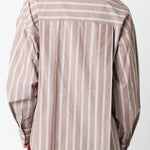 Woman wearing a striped shirt against a white background