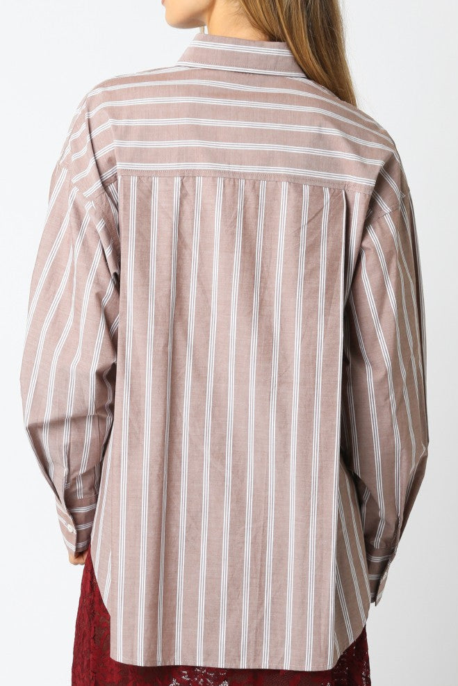 Woman wearing a striped shirt against a white background