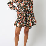 Woman wearing a floral dress on a white background