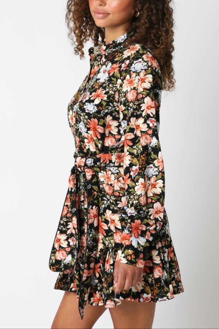 Woman wearing a floral dress against a white background