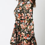 Woman wearing a floral dress against a white background