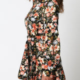 Woman wearing a floral dress against a white background