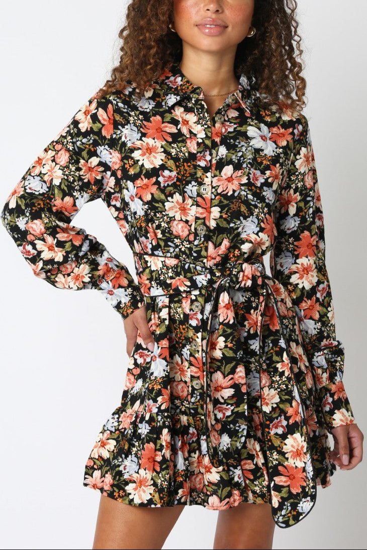 Woman wearing a floral dress against a white background