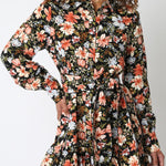 Woman wearing a floral dress against a white background