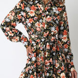 Woman wearing a floral dress against a white background