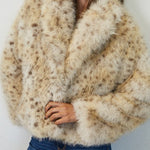 Woman wearing a fluffy beige coat against a white background