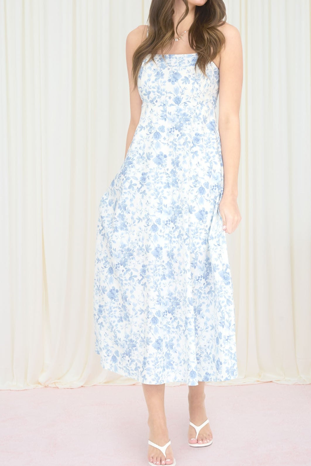 Woman in a floral dress standing in front of a vintage television set with 'Retro Bloom' text.