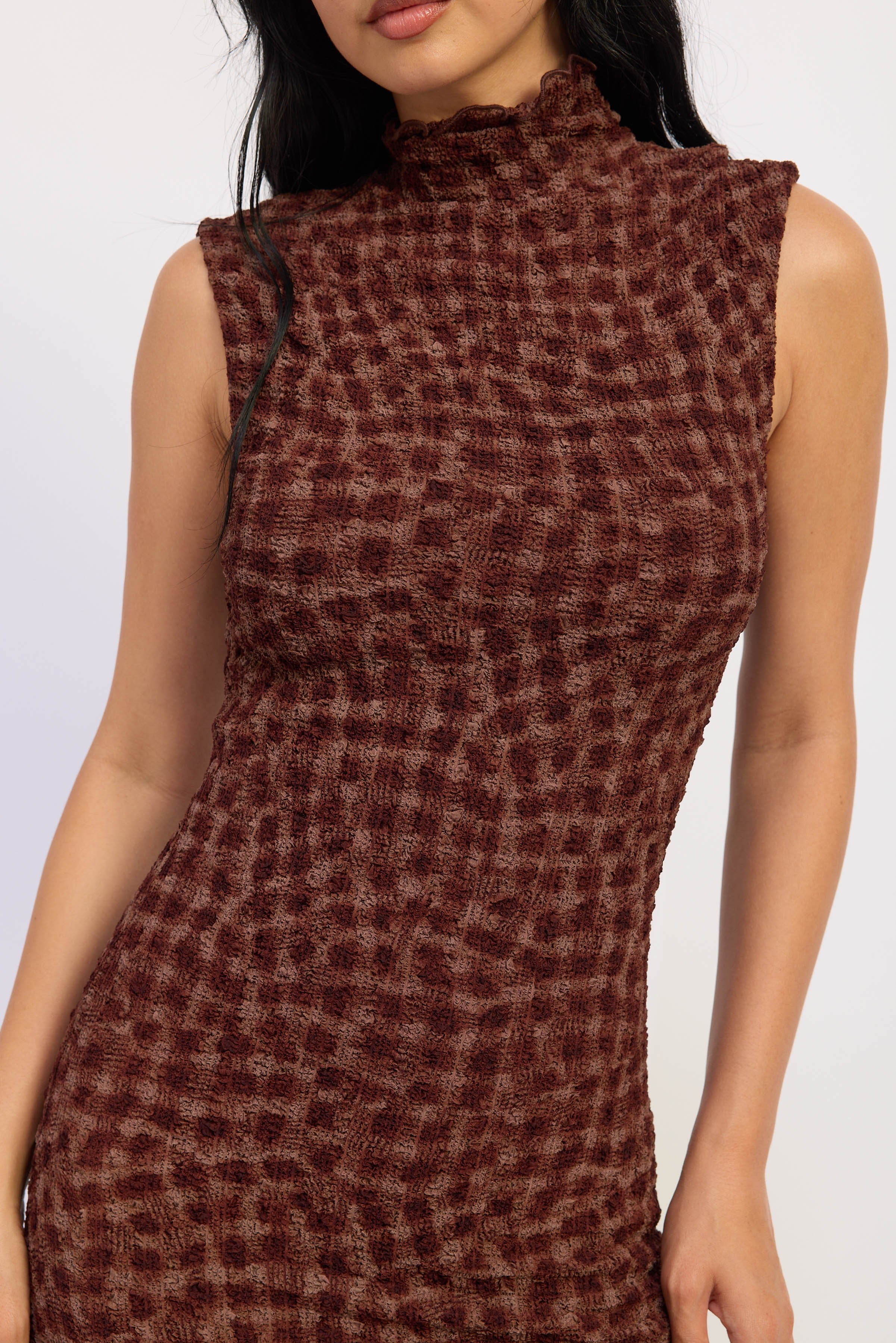 Close up of textured smocked check print fabric in espresso