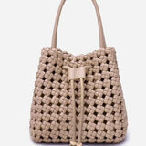 Beige woven handbag with drawstring on a light gray background
