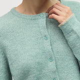 Close up of crew neckline, button front, and contrast trim