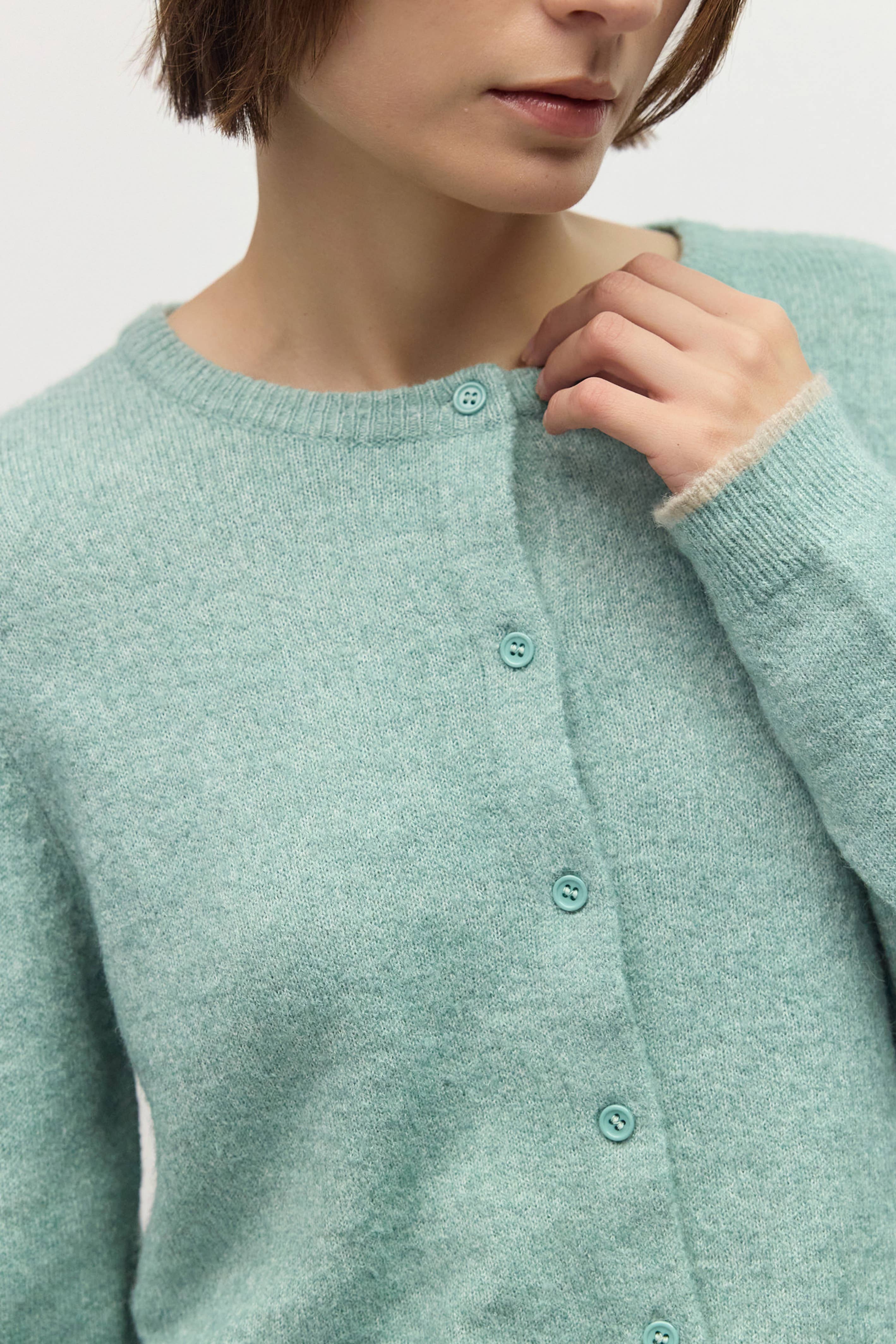 Close up of crew neckline, button front, and contrast trim