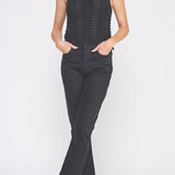Woman wearing a black sleeveless top and black pants on a white background