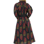 Woman wearing a black floral dress on a white background