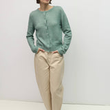 Knit cardigan with contrast trim, styled with cream trousers