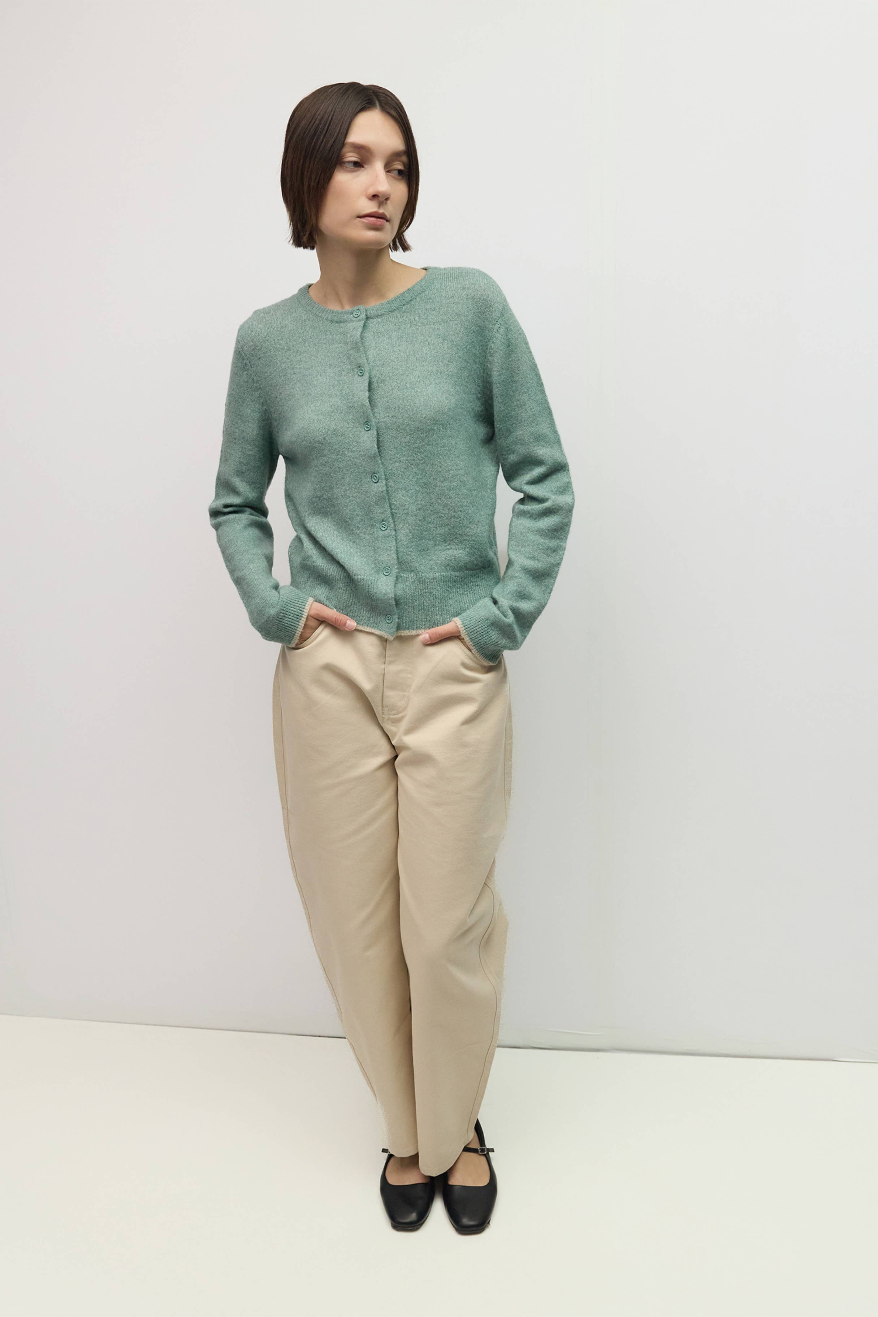 Knit cardigan with contrast trim, styled with cream trousers