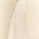 White pants with a subtle pattern worn by a person on a beige background