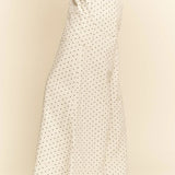 White pants with a subtle pattern worn by a person on a beige background
