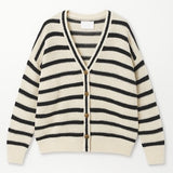 Striped cardigan with black and white stripes on a white background
