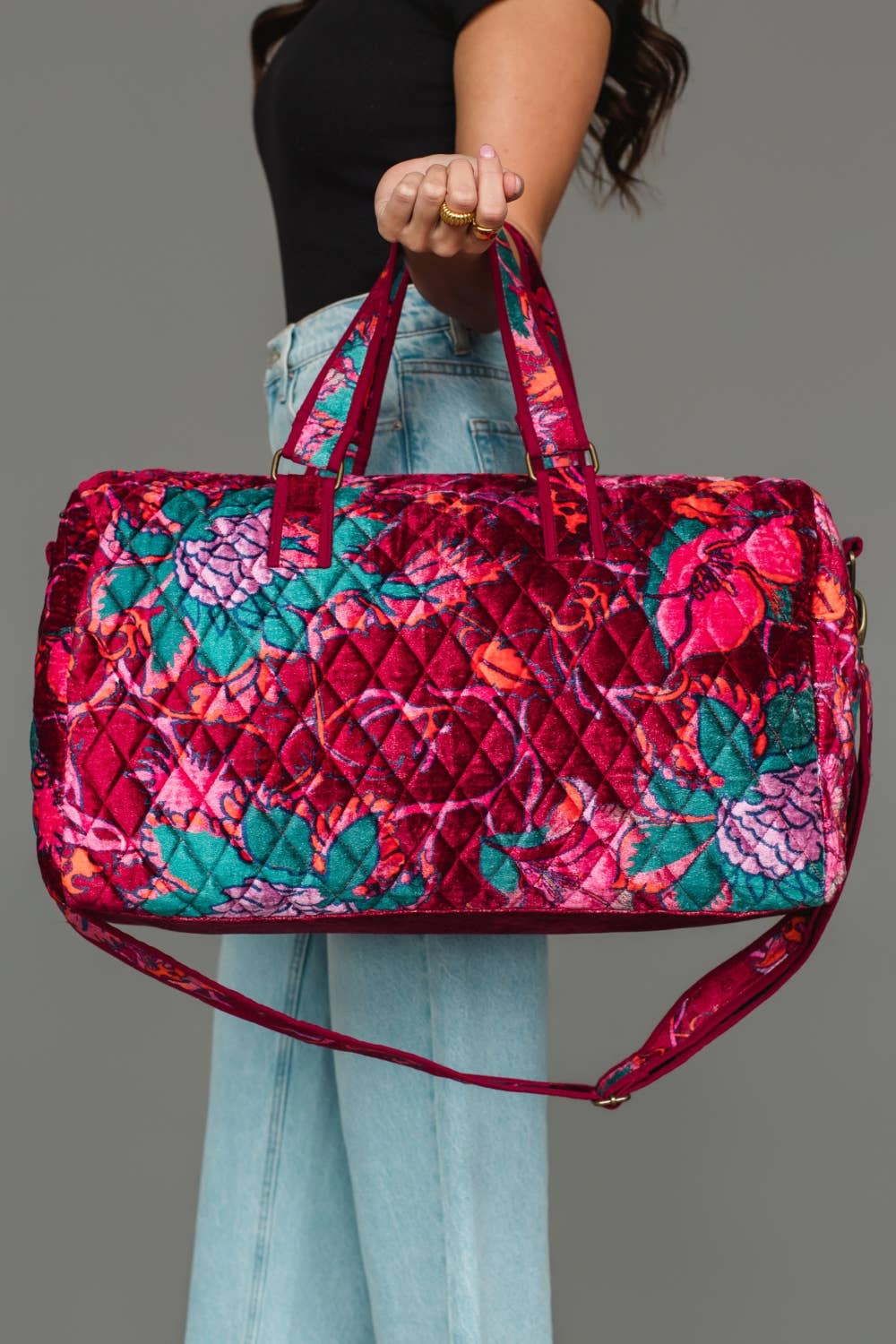 Wildflower Woven Duffel in burgundy floral, carried