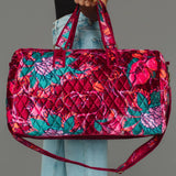 Wildflower Woven Duffel in burgundy floral, carried