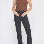 Woman wearing a brown ribbed top and black pants on a white background