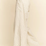 White pants with black polka dots on a beige background