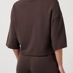 Woman wearing a brown outfit on a white background