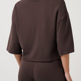Woman wearing a brown outfit on a white background