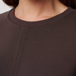 Close-up of a brown sweater with a focus on the neckline.