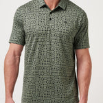 Man wearing a green patterned polo shirt against a white background