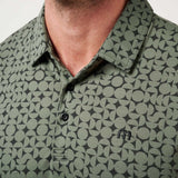 Green patterned polo shirt worn by a person