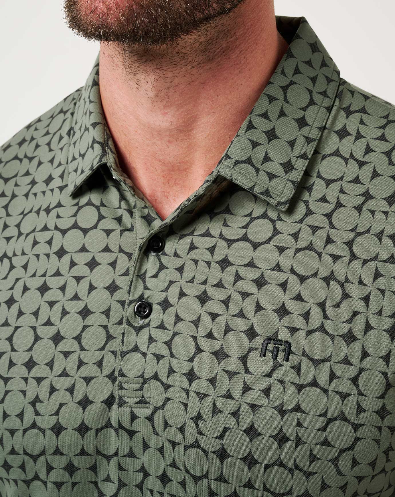 Green patterned polo shirt worn by a person