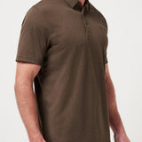 Man wearing a brown polo shirt against a white background