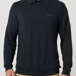 Man wearing a black long-sleeve polo shirt with a logo on a light gray background