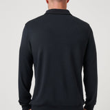 Man wearing a black long-sleeve shirt against a white background