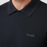 Black polo shirt with a brand logo on a plain background