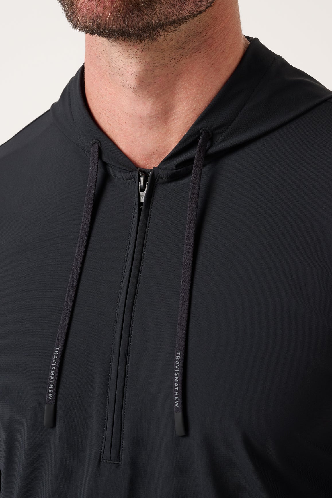 Travis Mathew Hero Hour Tech Hoodie in Black, detail