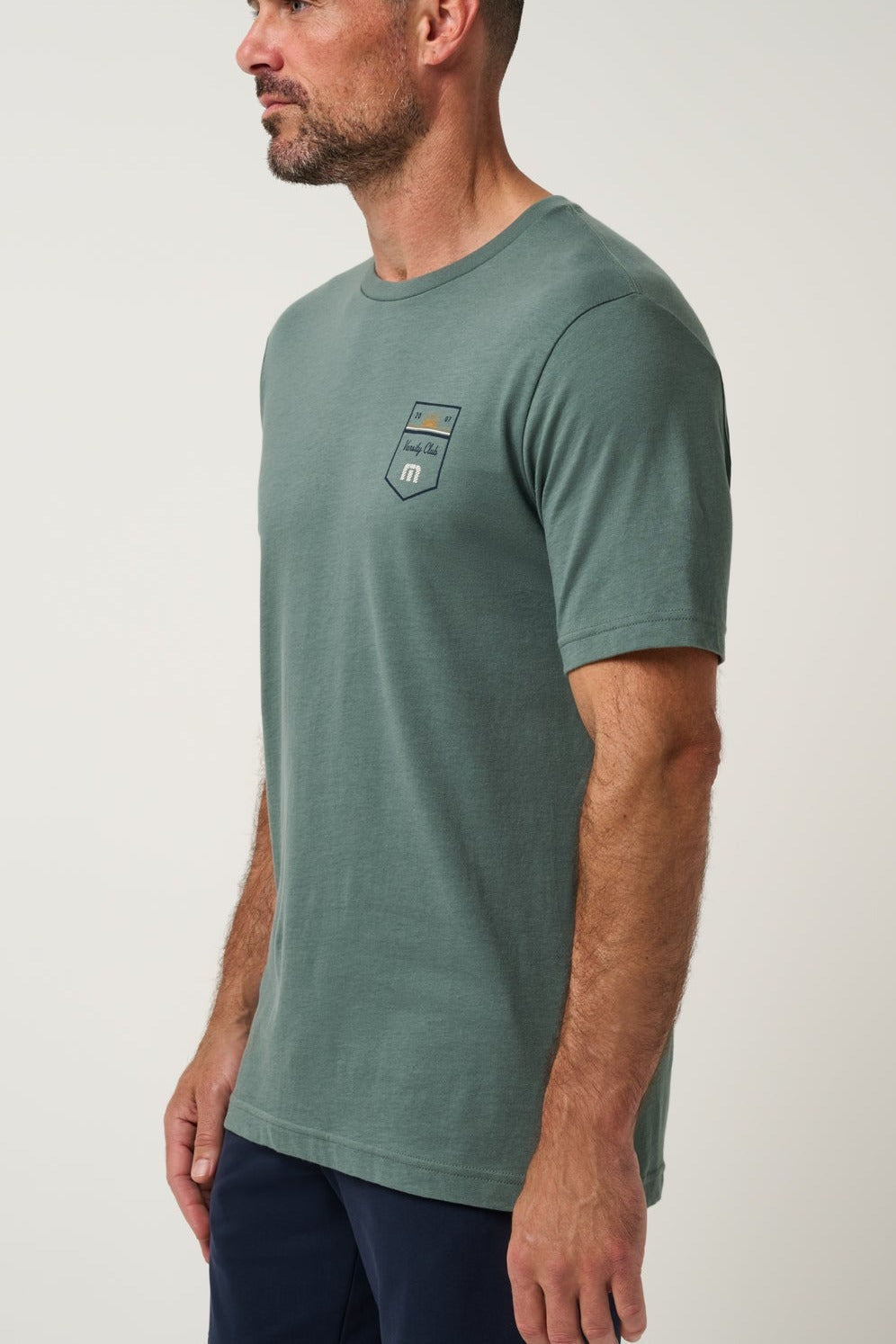 Travis Mathew Club Charm Tee in Balsam Green, side view
