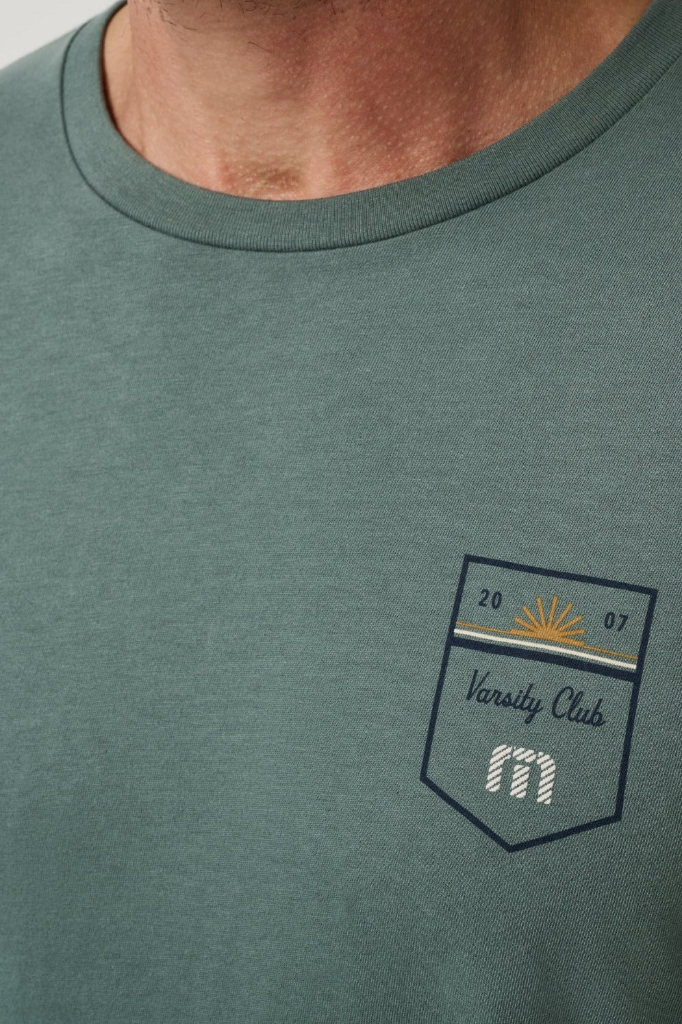 Travis Mathew Club Charm Tee in Balsam Green, back view