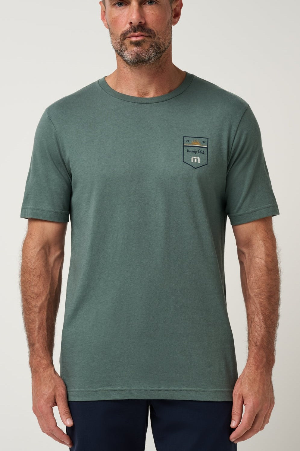 Travis Mathew Club Charm Tee in Balsam Green, detail view