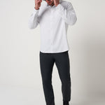 Model wearing the White Techwoven Cross Check Button-Up with dark pants