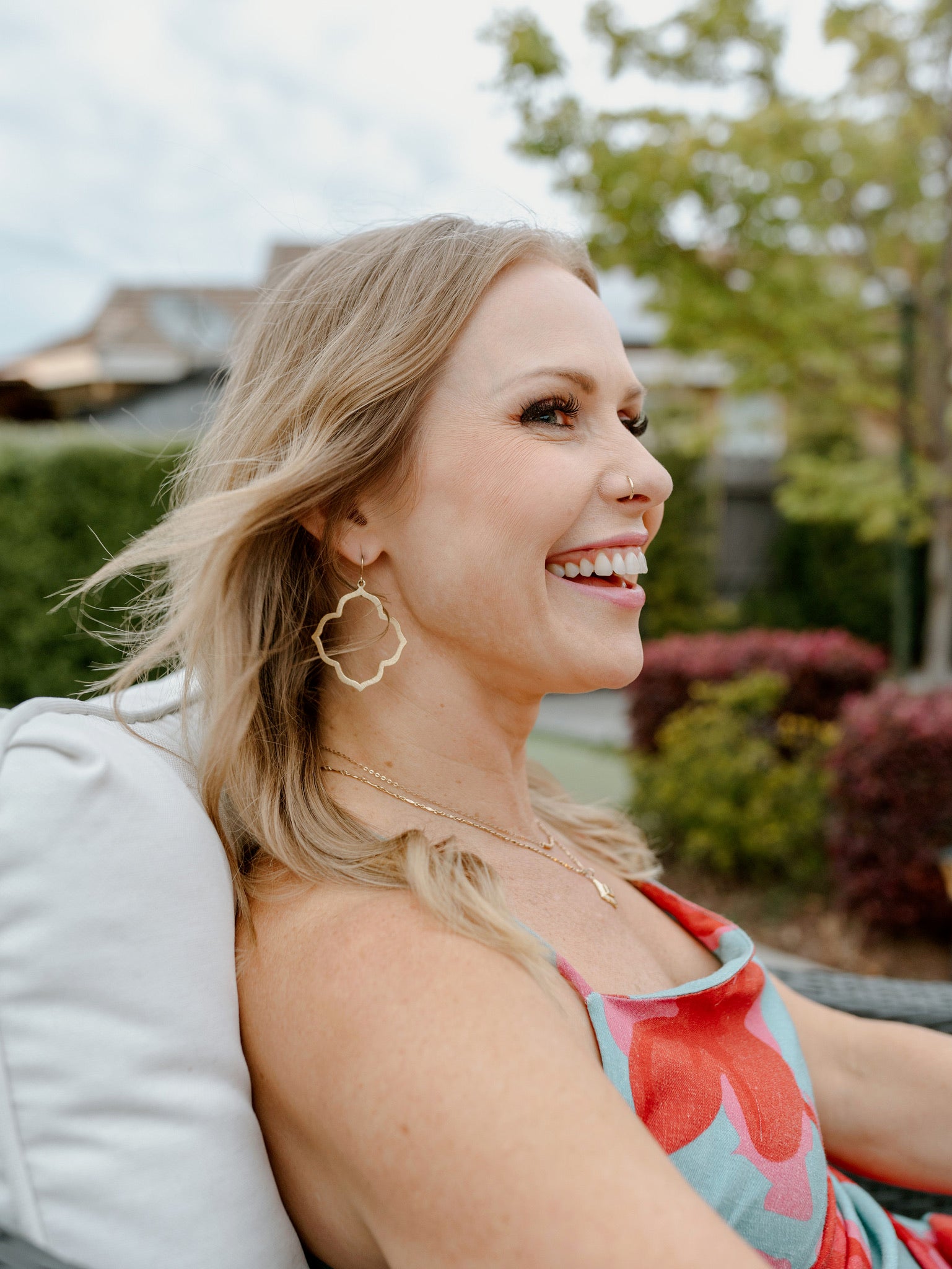 Smiling woman with gold filled earings and necklace